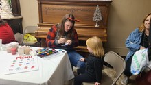 CITY RESIDENT MICHELLE COLE VOLUNTEERS TO HELP FACE PAINTING.