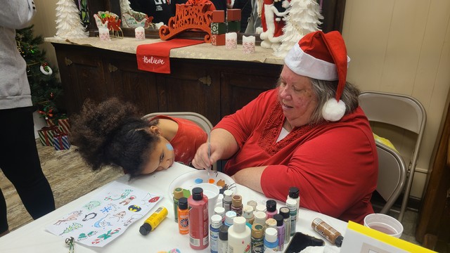 MRS. JOY, A FAITHFUL COLBERT RESIDENT, DOES FACE PAINTING ALSO IN THE DEPOT.